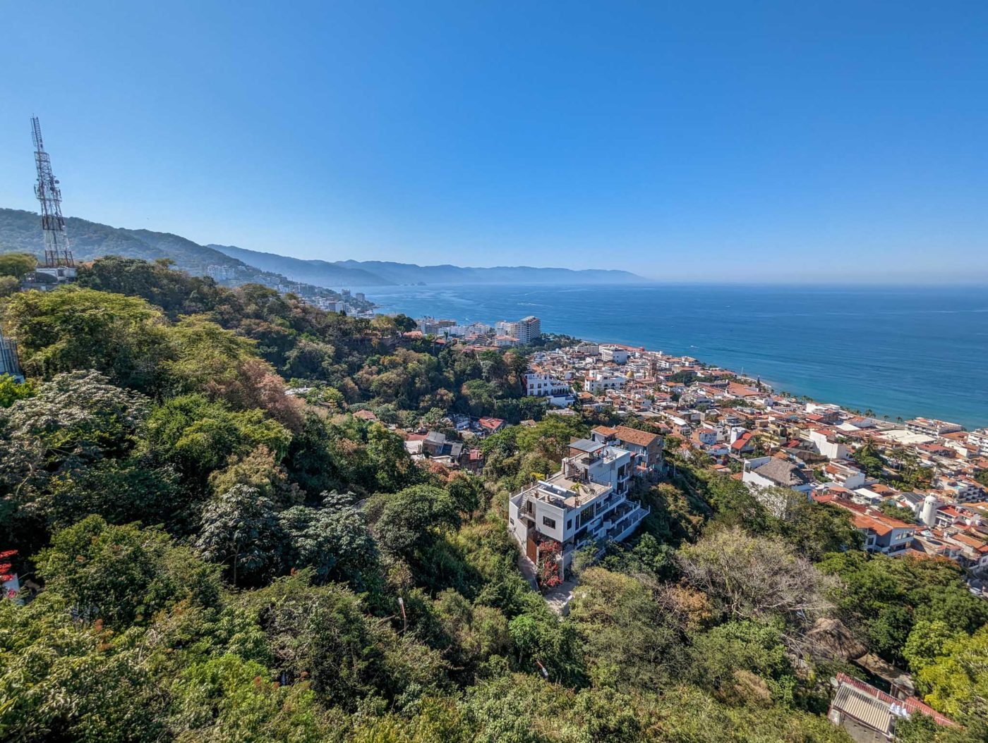 an aerial view of a city and the ocean.