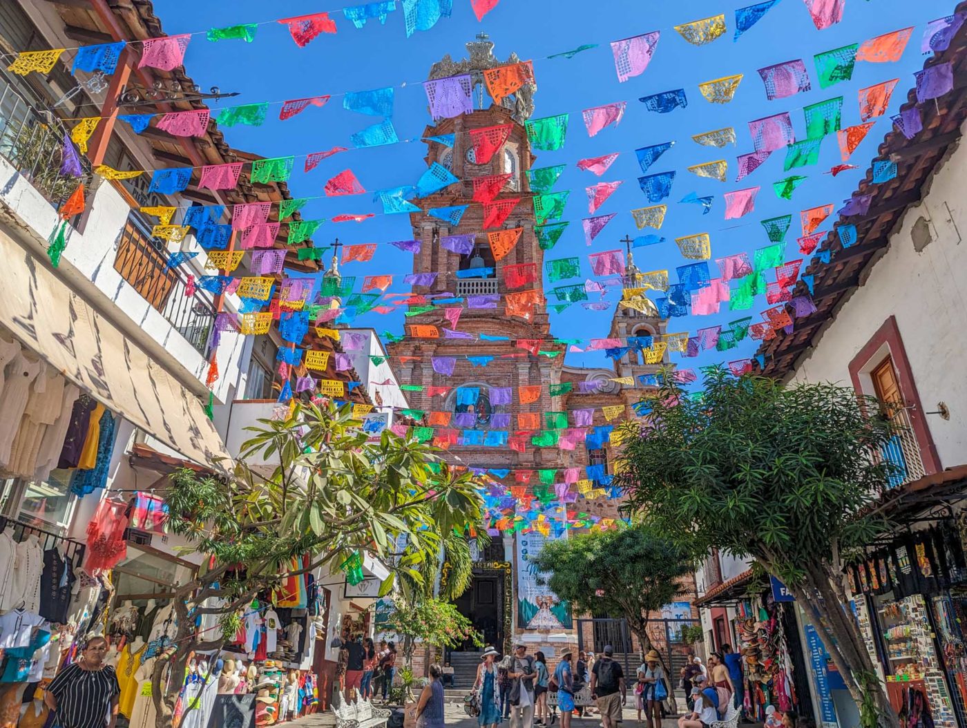 a city street filled with lots of colorful flags.