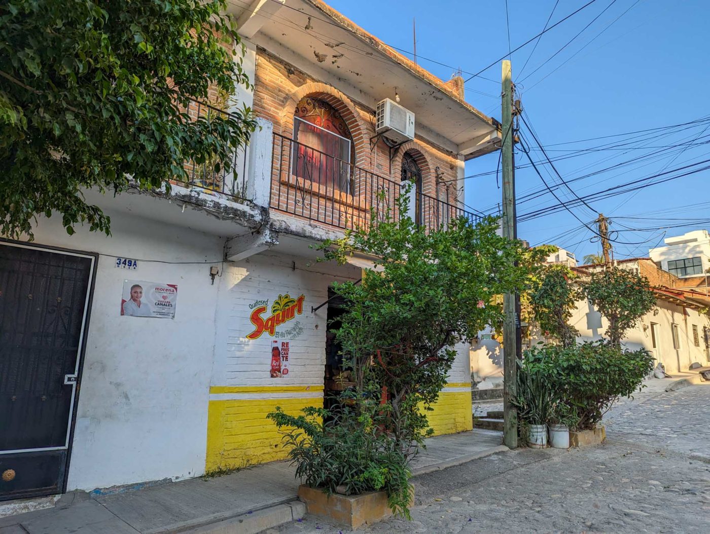 a white building with a yellow and yellow painted wall.