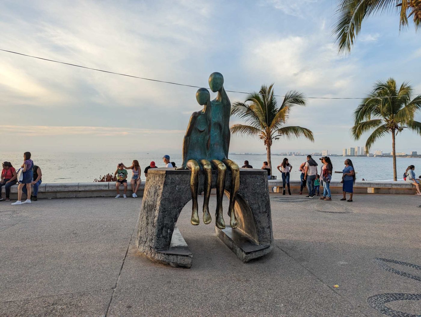 a group of people standing around a statue.