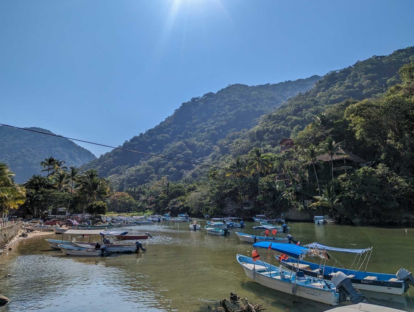 a group of boats sitting on top of a river.