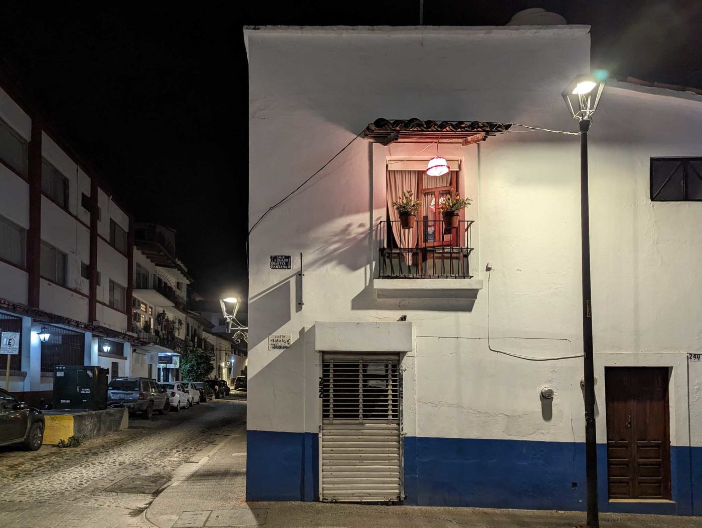 a white building with a blue and white stripe on the side of it.