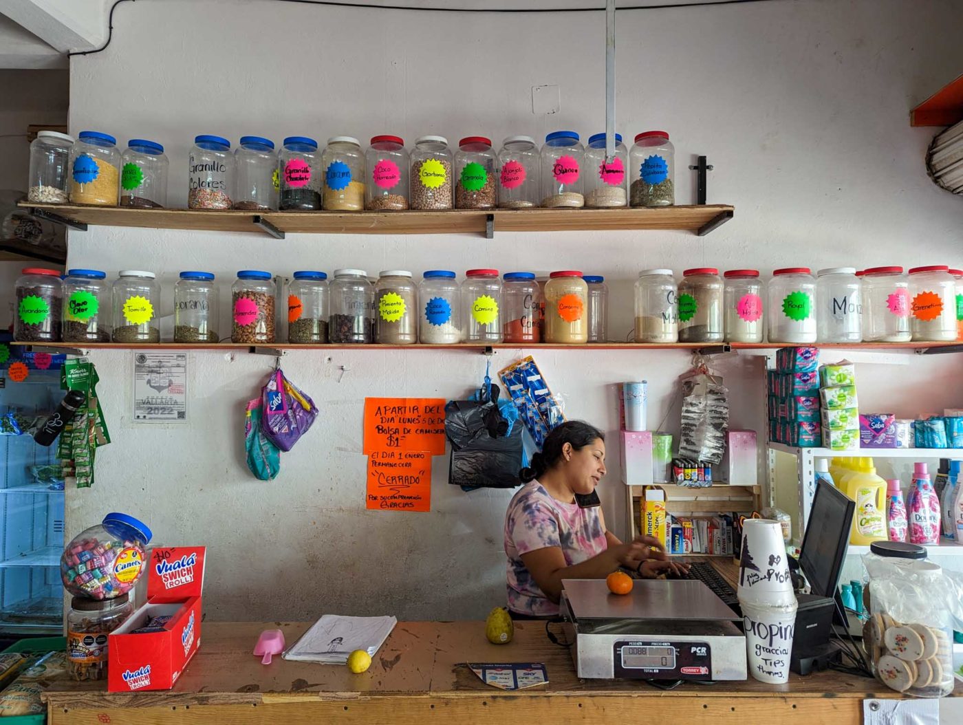 a woman sitting at a counter in a store.