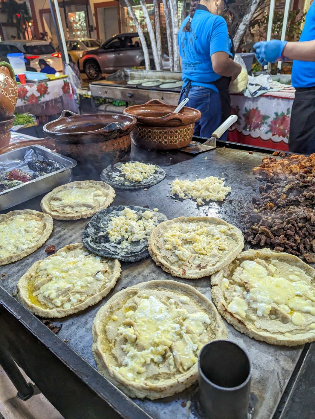 a table topped with lots of pies covered in toppings.