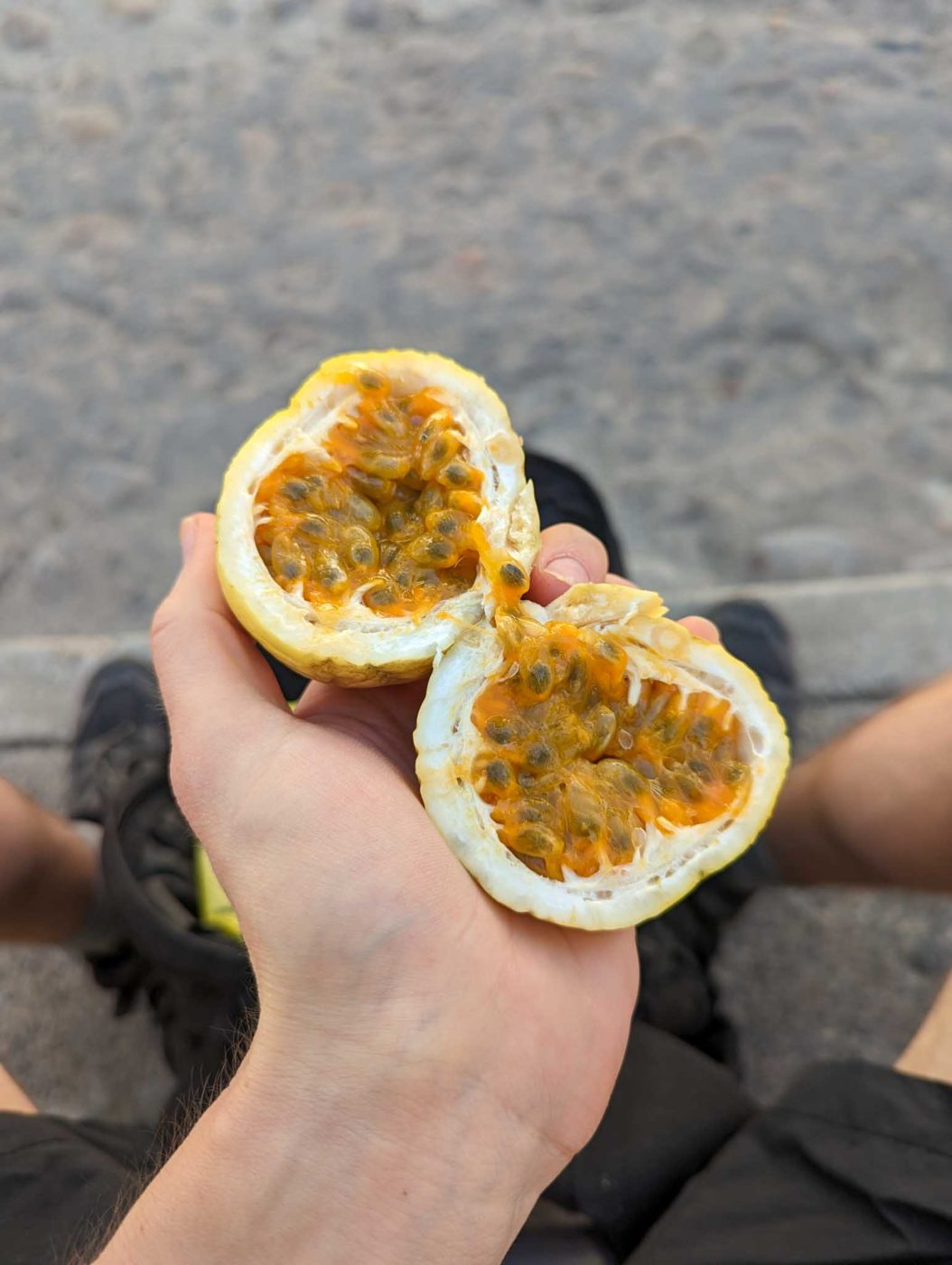 a person holding a half eaten orange in their hand.