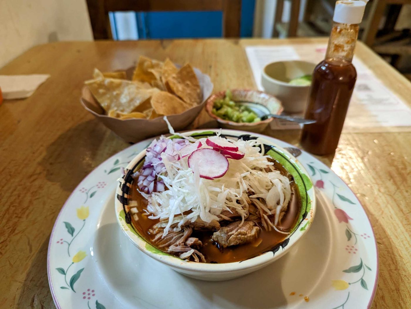 a bowl of food on a plate on a table.