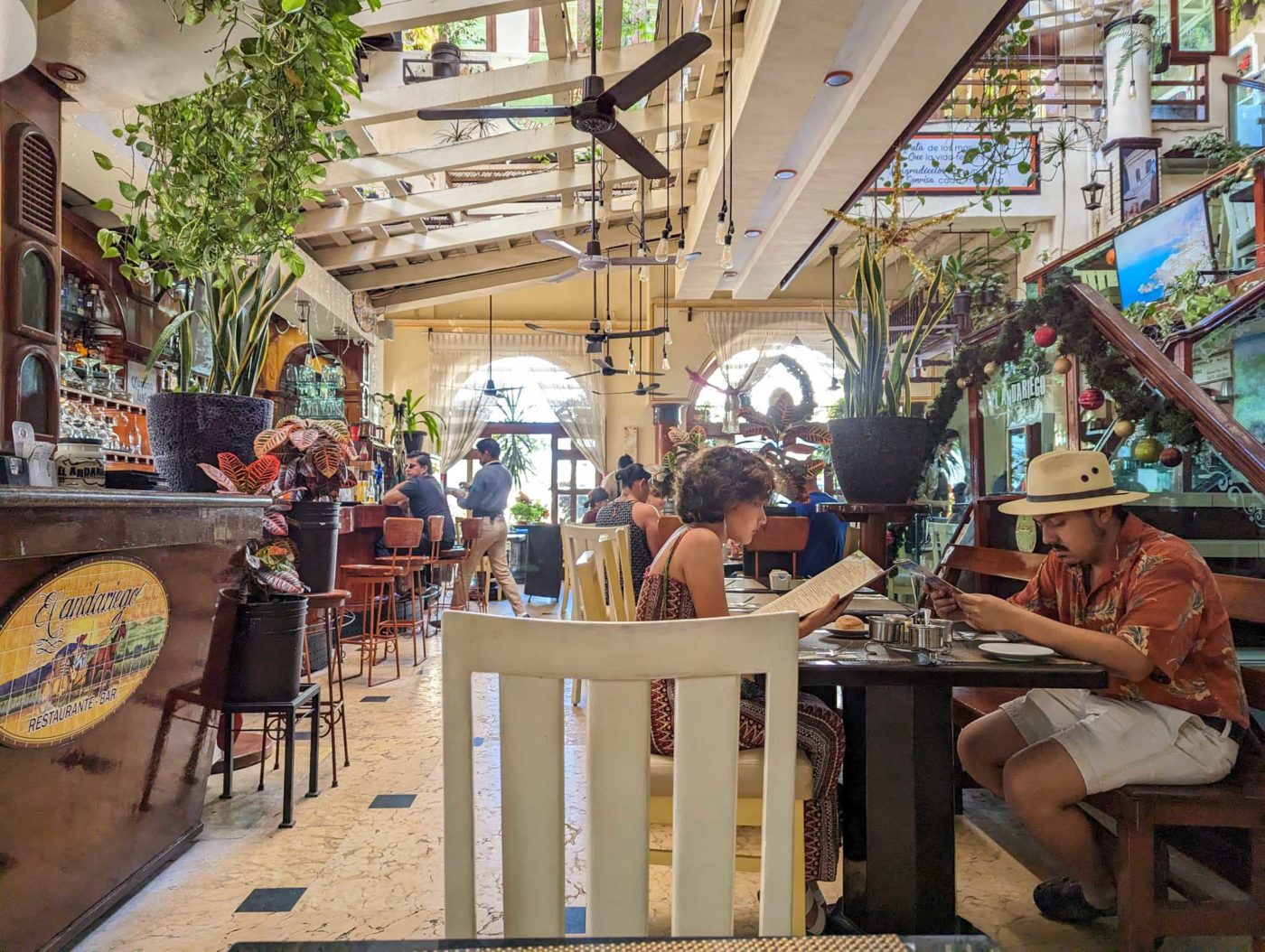 a man sitting at a table in a restaurant.